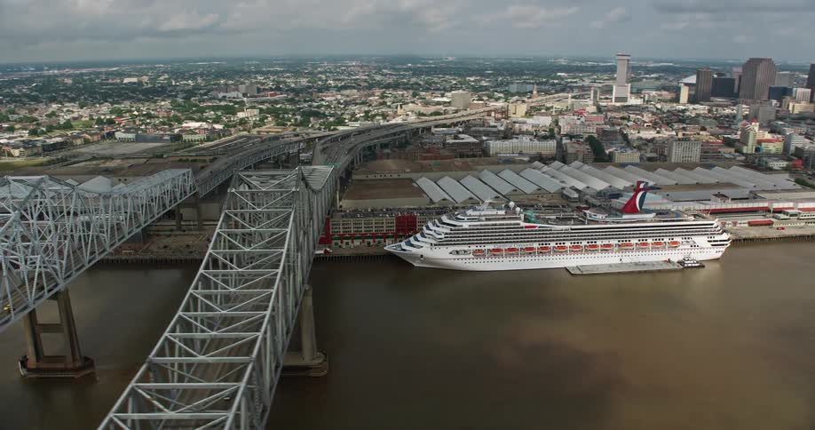 A breathtaking 4K aerial footage of downtown New Orleans during summer capturing the towering high-rises and a large cruise ship docked at the bustling harbor
