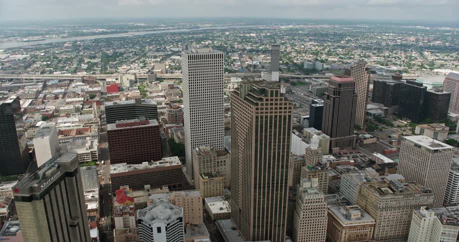 Approaching Downtown New Orleans high-rises from the French Quarter on a partly cloudy day in 4K aerial stock footage