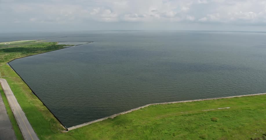 An aerial approach to New Orleans Lakefront Airport in Louisiana on a partly cloudy day