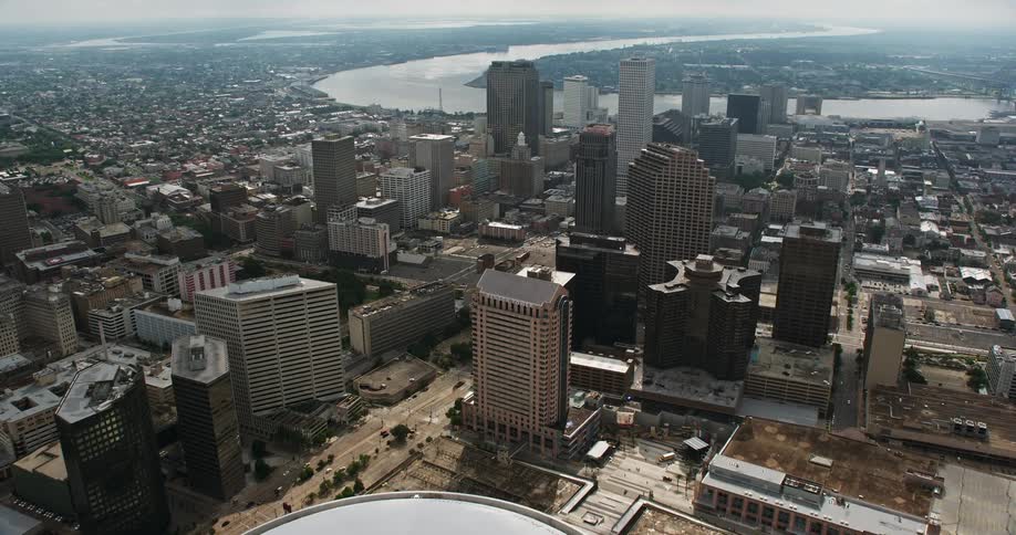 An aerial flyover view of New Orleans Superdome and downtown area to the Mississippi River