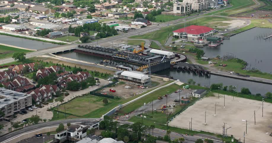 Orbiting aerial view of 17th Street Canal and pumping station in Metairie Louisiana during a partly cloudy day