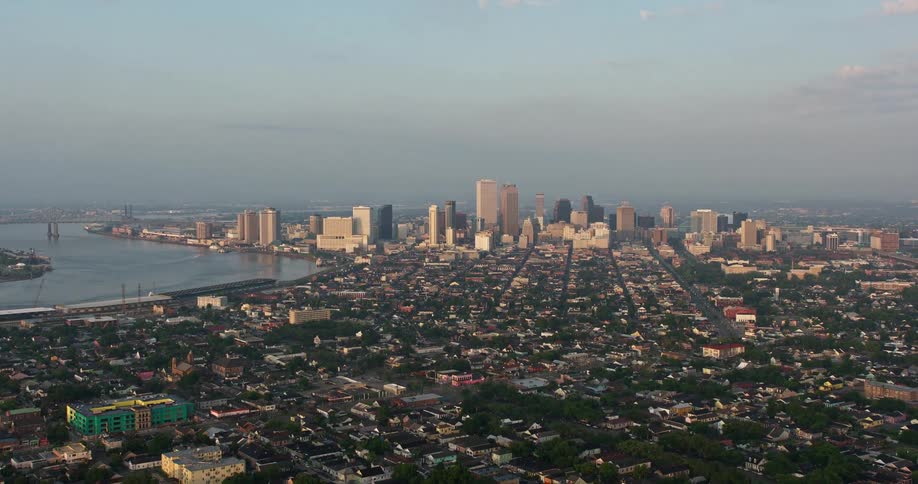 Approaching the French Quarter and downtown New Orleans during a stunning sunrise in 4K aerial footage