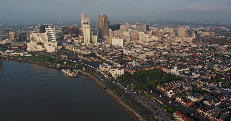 Aerial footage of St Louis Cathedral and Jackson Square at sunrise revealing the downtown New Orleans skyline and city park