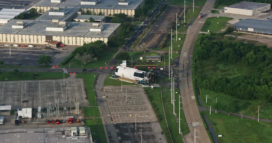 A 4K aerial view shows an orbit around a booster rocket at a NASA factory during sunrise in New Orleans East Louisiana
