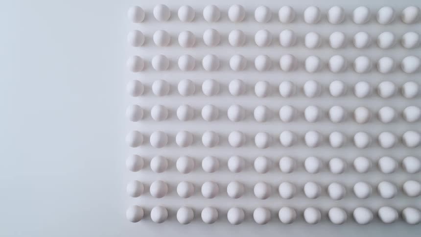 Eggs on a table are on display in rows
