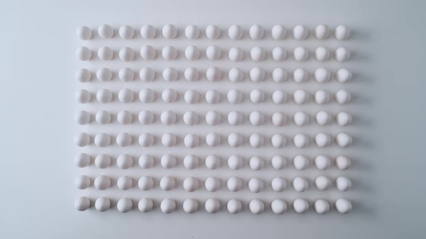 Eggs are displayed in rows and columns on a table