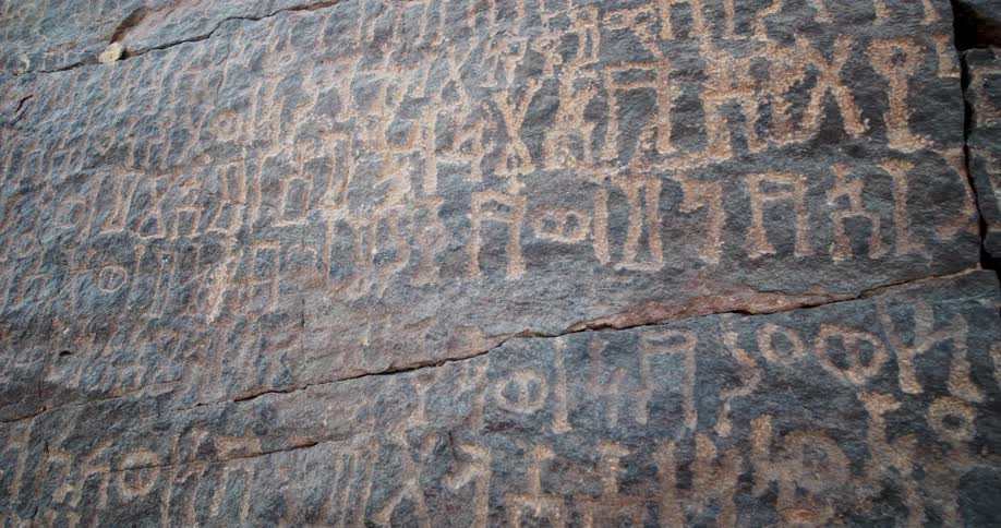 Petroglyphs from a lost alphabet cover a large rock in Saudi Arabia
