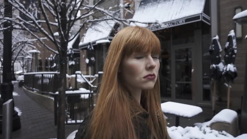 A woman is walking down a city street