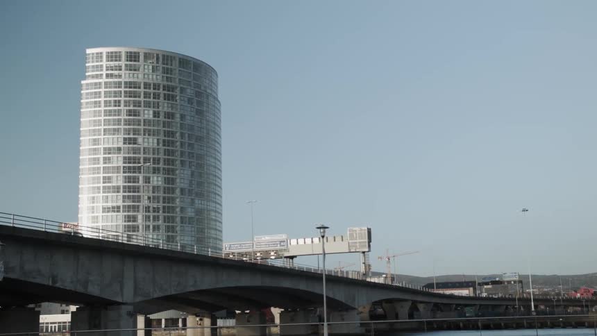 A glassy building near a bridge
