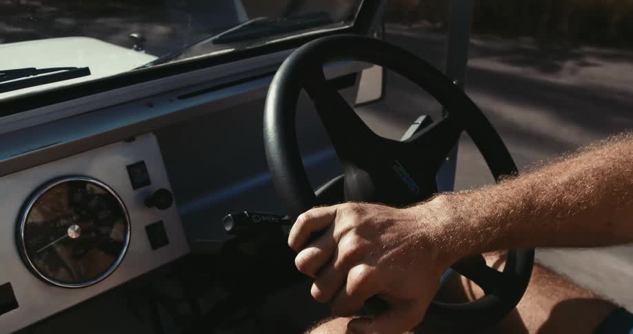 Close up view of a man driving a car outdoors in spring
