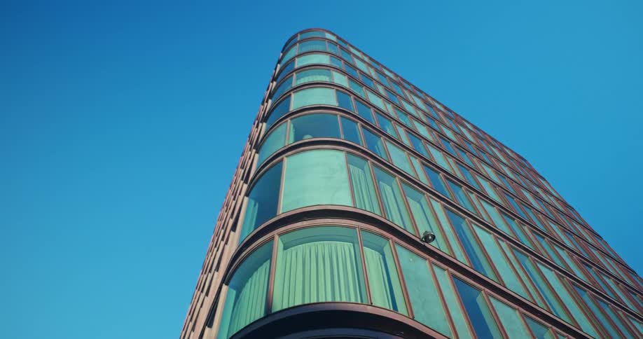 A tall building in an urban city is displayed