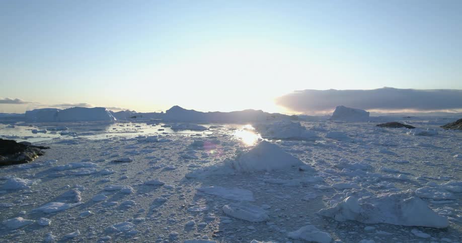 The snow is melting in the ocean water at dusk