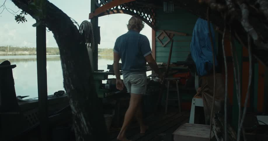 Man walking into work at activities desk or equipment rental on the beach