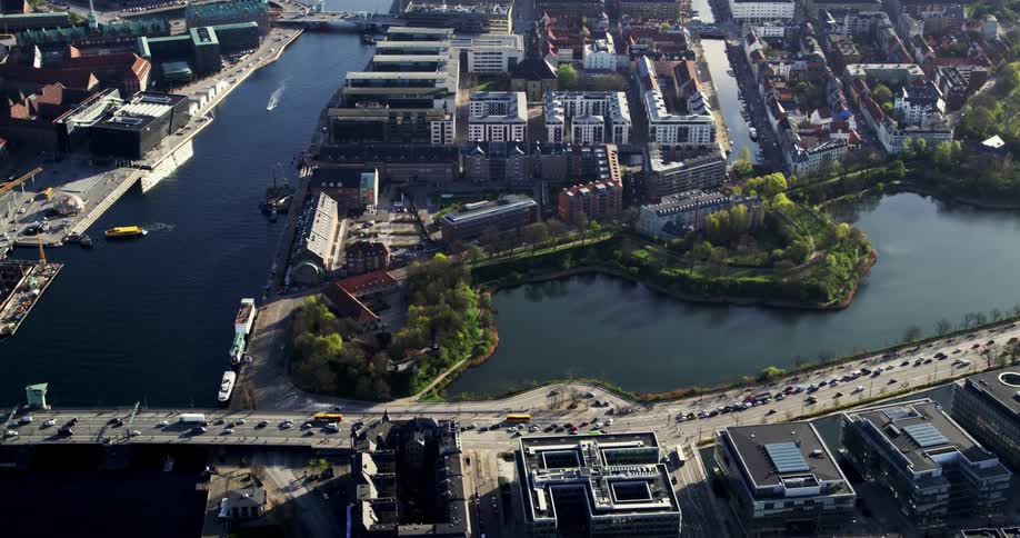 An aerial view of a city on the water with bridges leading to an island full of buildings