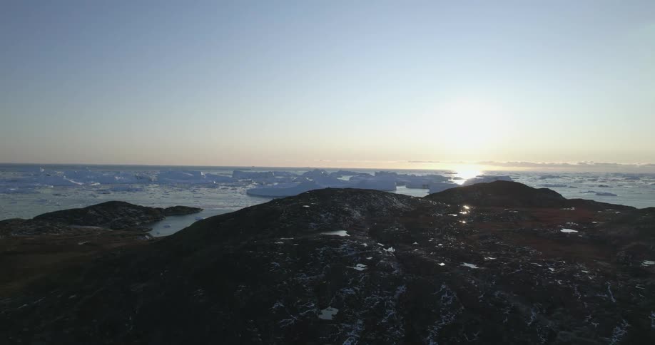 The sun is setting in the arctic landscape