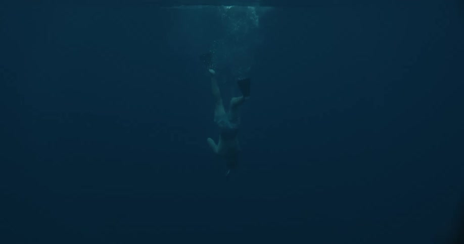 Person diving underwater in the ocean