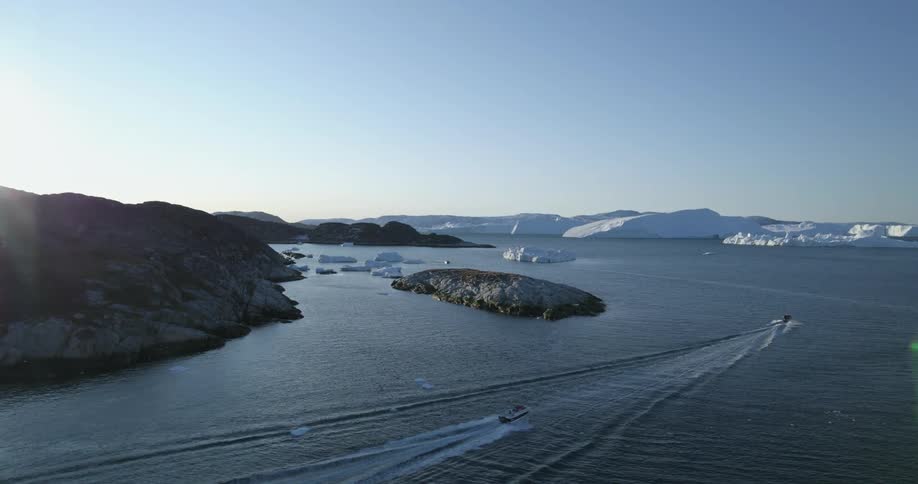Sailboats are driving through ocean water during winter
