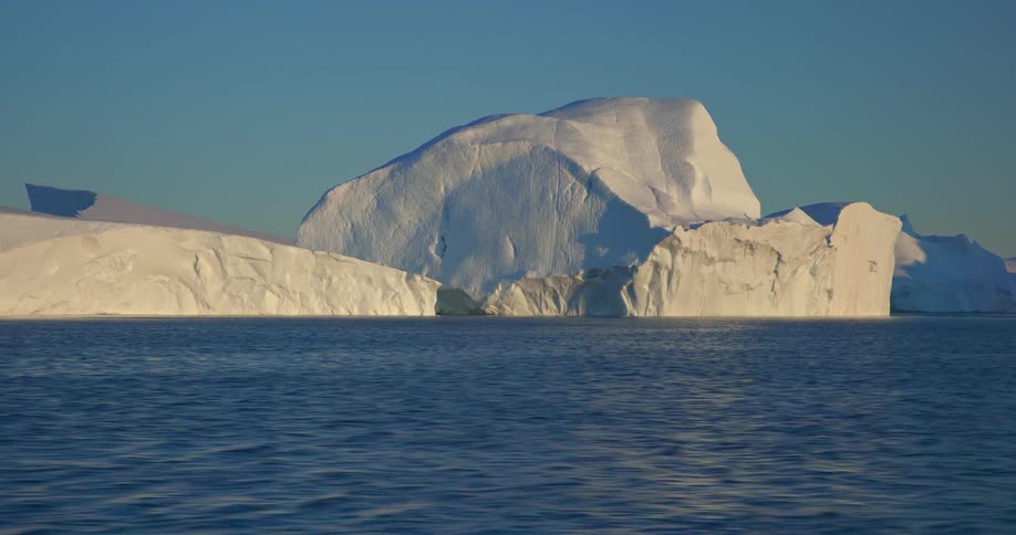 A large iceberg formation on the ocean as the ocean ripples across the surface