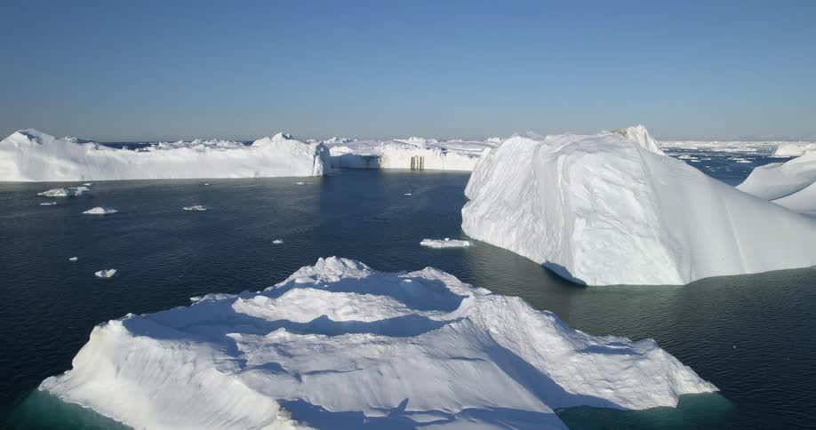 An aerial of icebergs and glacier in the ocean