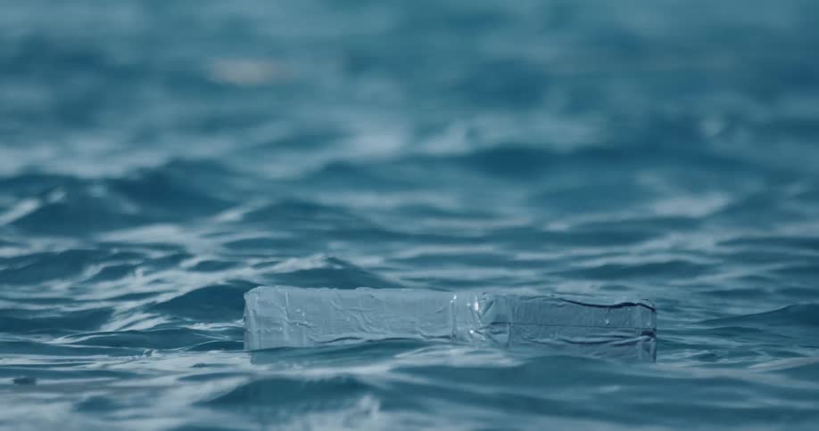 A block of plastic floating in icy deep blue ocean