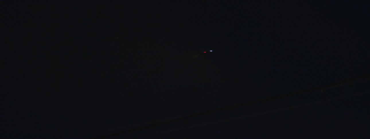 A plane flies by at night
