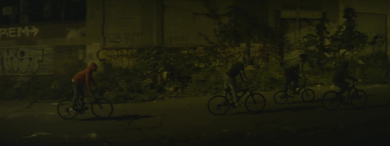 People ride their bikes together at night