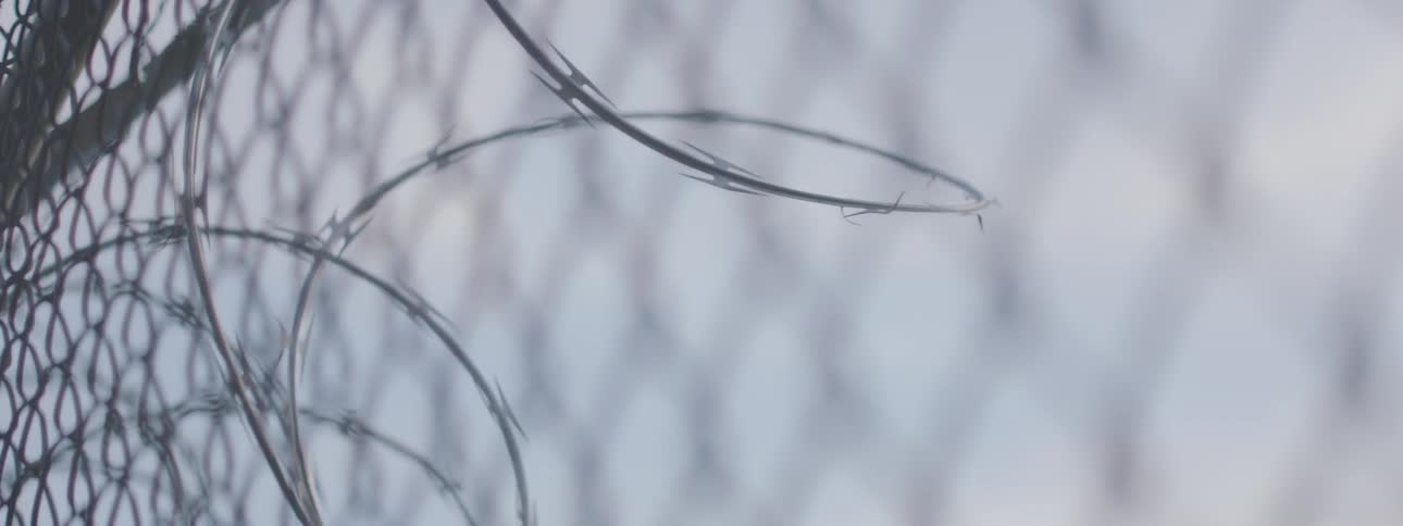 Barbed wire in front of a chain link fence