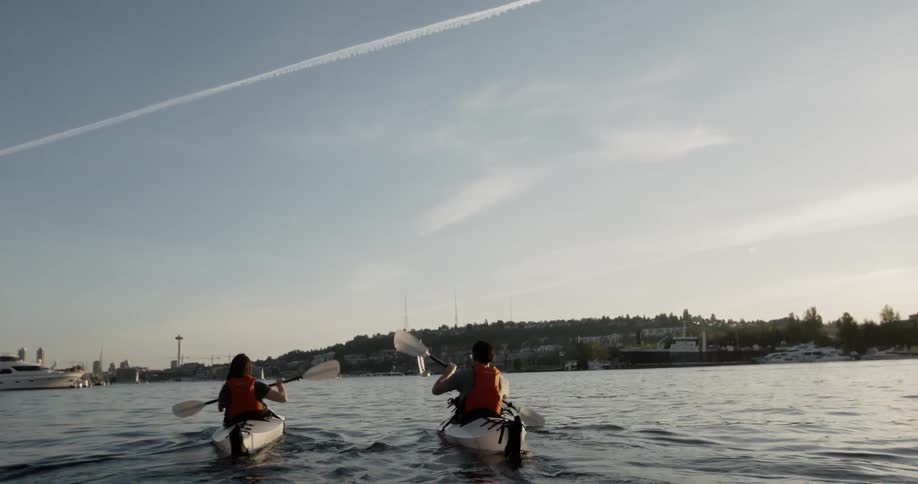 People kayak across a river