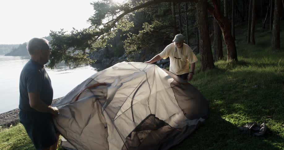 Two people set up a tent