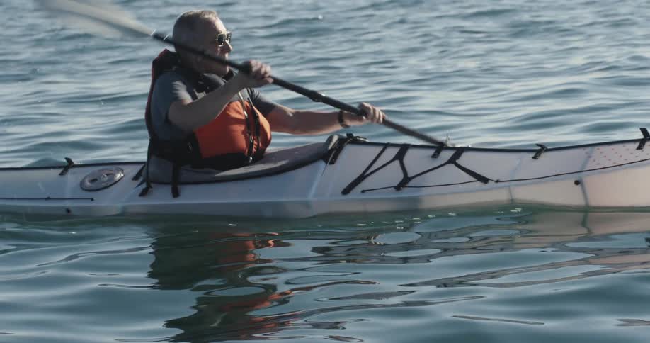 A man is rowing in a canoe
