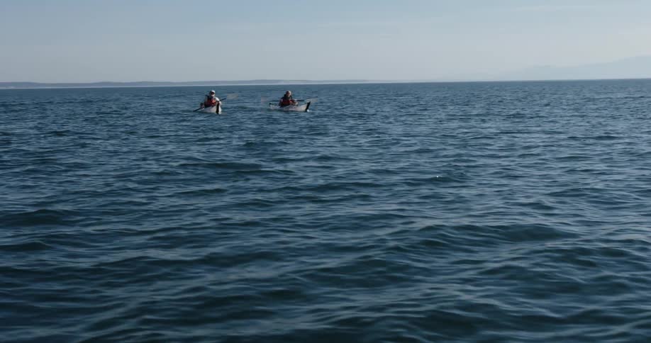 People kayak in the open water