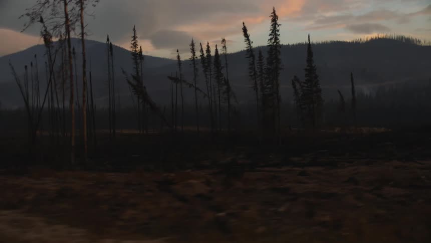 A view of a landscape while the sun is setting