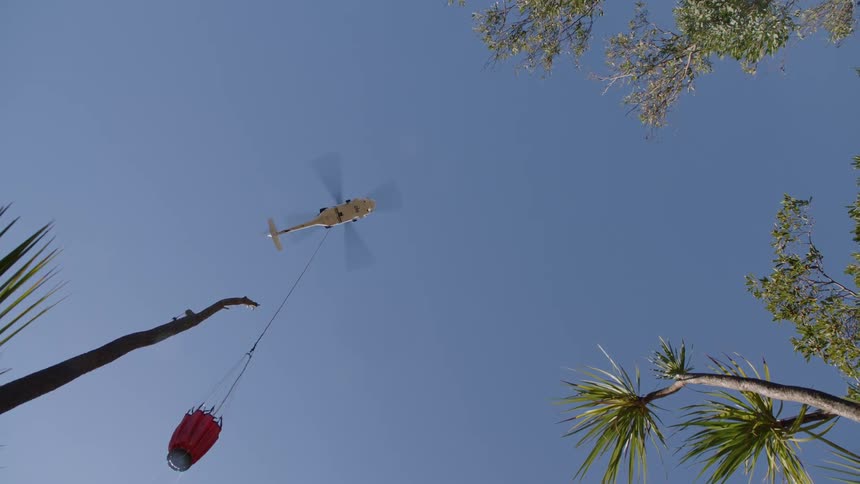 Helicopter bucket suspended on a cable carried by a helicopter to deliver water for aerial firefighting