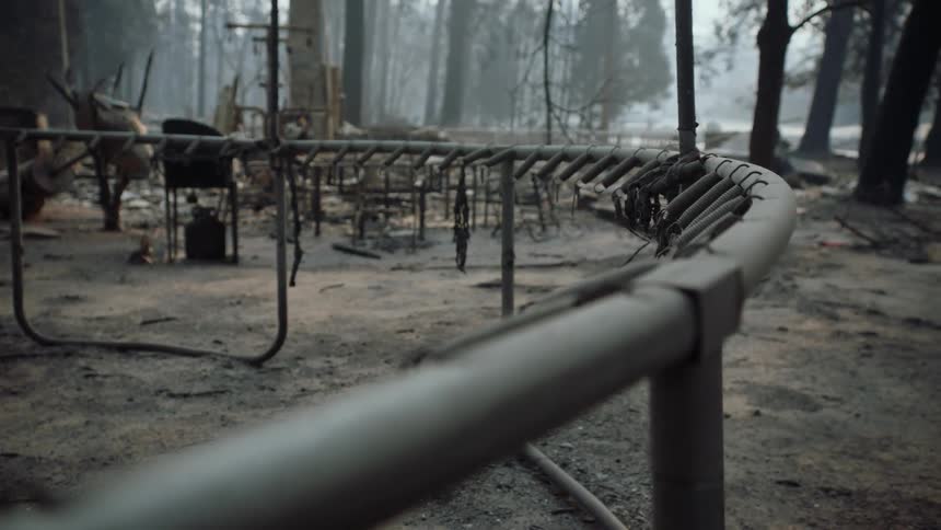 A burnt and destroyed trampoline near other debris