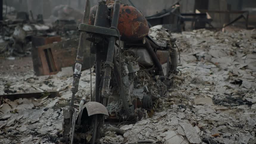 Charred motorcycle in the aftermath of a fire