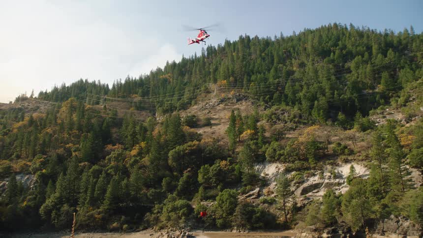 The helicopter carries the ball out of the water