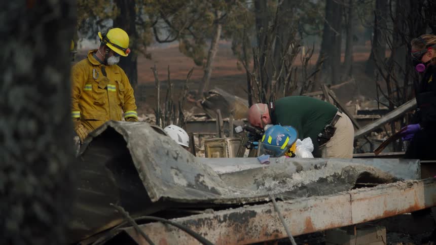 Firefighters search through the debris of a structure