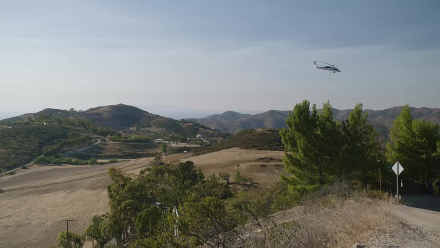 A helicopter is flying over the landscape in spring