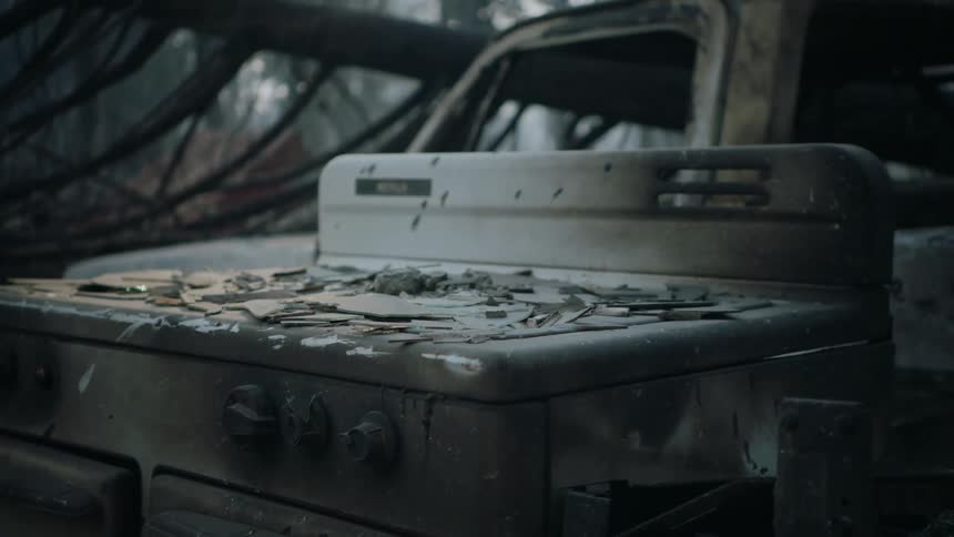 Close up of a burned stove top gas oven inside a burned down house