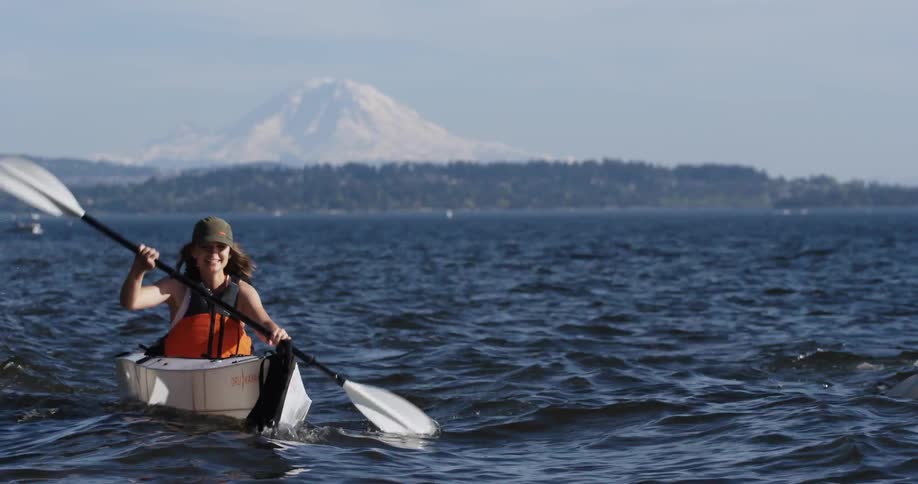 Two people row in a canoe side by side