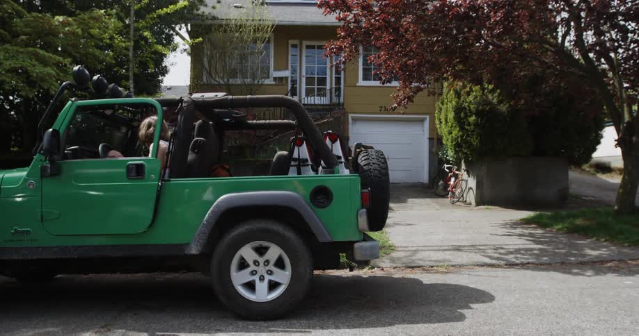 A girl is getting into a jeep