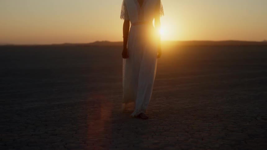 A woman is walking in the desert