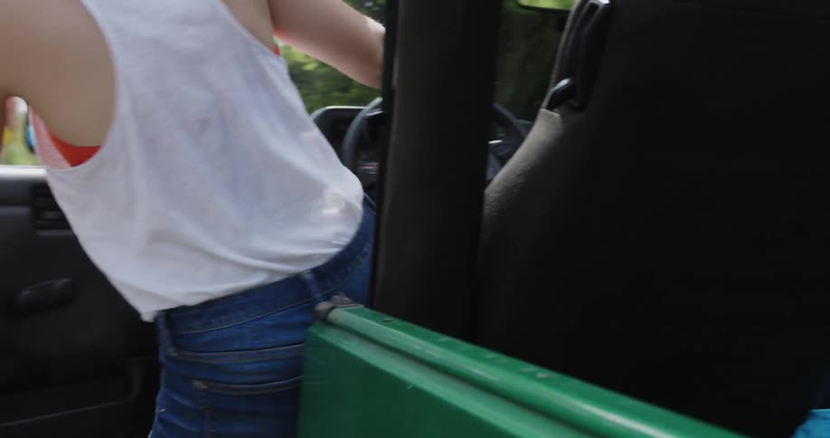 A woman gets into a jeep