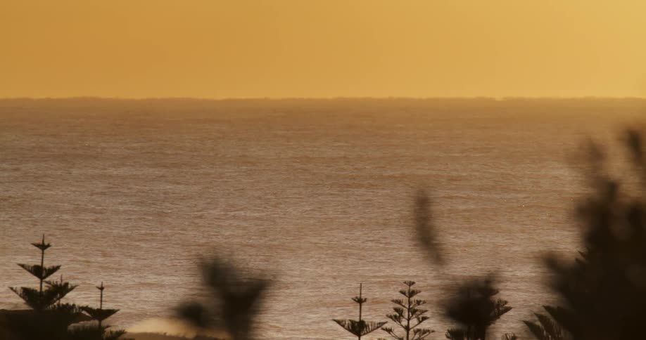 Panoramic view of the ocean under the yellow sky at evening