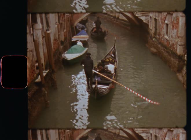 Canoe boats or gondolas being paddled through a narrow river or canal between buildings and a bridge while a group of people or tourists is being transported via water taxi while sightseeing in Venice Italy