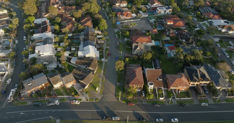 Vehicles line streets in residential neighborhood of larger homes