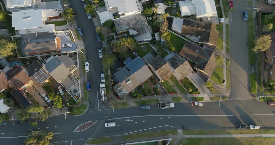 Aerial view above a suburban area with similar houses upper middle class homes and little traffic