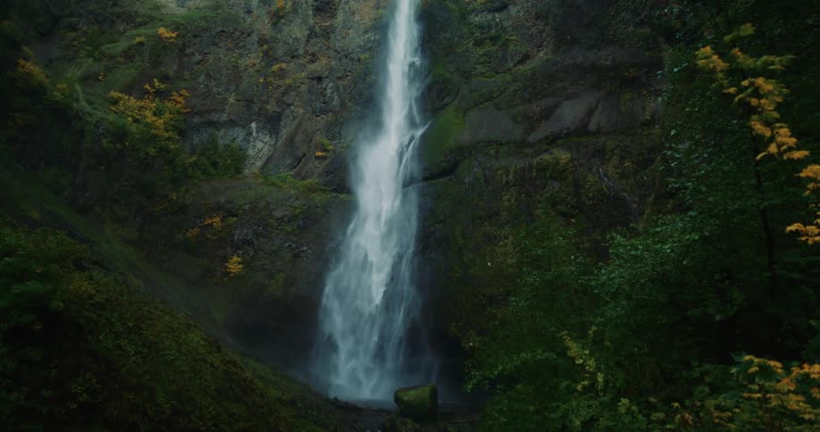 A raging waterfall cascades down a rock wall