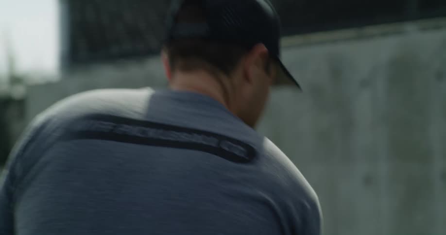 A man swings a tennis racket as he warms up