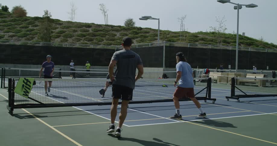 Men are playing a tennis match